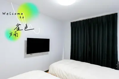 a bedroom with two beds and a television on the wall at Liberty Corp 101 - Vacation STAY 16233 in Tokyo