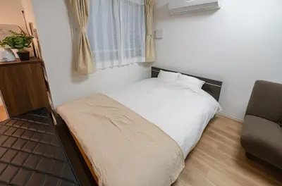 a small bedroom with a bed and a chair at Repure Omori Residence - Vacation STAY 16384 in Tokyo