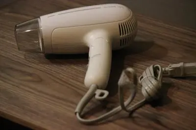 a hair dryer sitting on top of a wooden table at \u76ee\u9ed2\u672c\u753a\uff5cMeguro Honcho in Tokyo