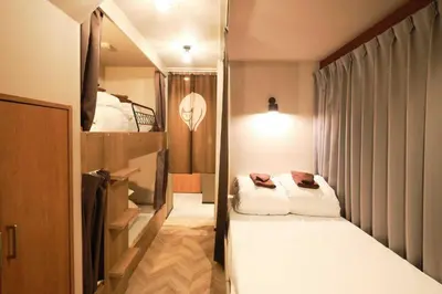 a small room with a bed and a tv at \u76ee\u9ed2\u672c\u753a\uff5cMeguro Honcho in Tokyo