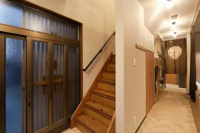 a hallway with a staircase with a door and a stair case at \u76ee\u9ed2\u672c\u753a\uff5cMeguro Honcho in Tokyo