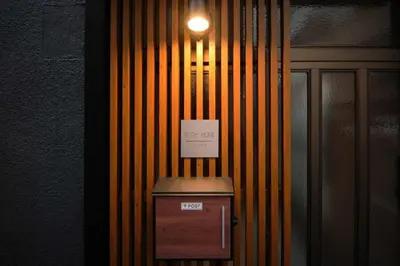 a light on a wall with a box with a sign on it at \u76ee\u9ed2\u672c\u753a\uff5cMeguro Honcho in Tokyo