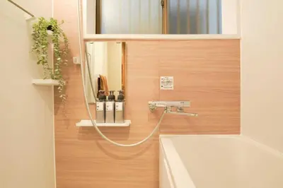 a bathroom with a tub and a sink and a mirror at \u76ee\u9ed2\u672c\u753a\uff5cMeguro Honcho in Tokyo