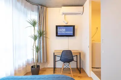 a room with a desk and a tv on a wall at Dash Living Kagurazaka in Tokyo
