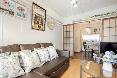 a living room with a couch and a table at 東京の中心地の新宿区で便利/2駅から徒歩6分/6名収容/無制限高速WIFI in Tokyo