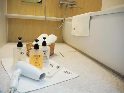 a bathroom with three bottles of hygiene products on a counter at \u685c\u306e\u5ddd17 JR\u4e0a\u91ce\u99c53\u5206\u949f 13\u4eba\u623f 5LDK 110\u5e73\u522b\u5885\u4e28Ueno Villa 3 minutes from Ueno Station 13 people in Tokyo