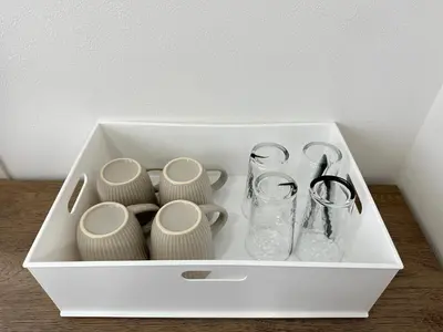 a white box filled with vases and glasses on a table at nestay miriz tokyo ikebukuro in Tokyo
