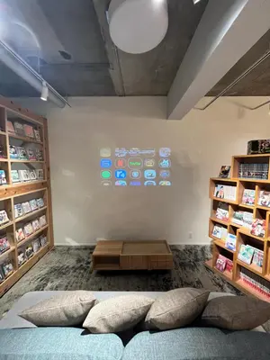 a room with a bed and a wall with a display at MANGA ART HOTEL, BAKUROCHO in Tokyo
