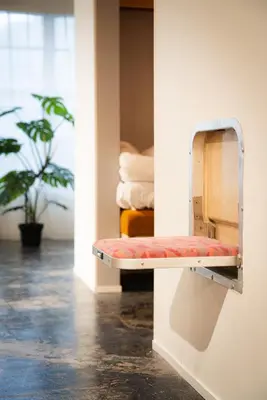 a bench in a room with a plant at MANGA ART HOTEL, BAKUROCHO in Tokyo