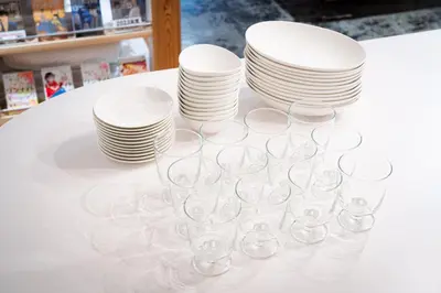 a group of plates and wine glasses on a table at MANGA ART HOTEL, BAKUROCHO in Tokyo