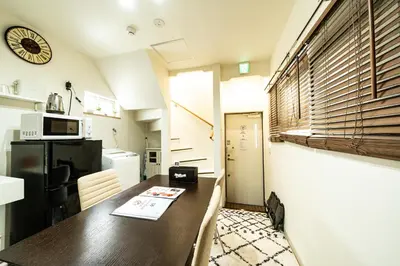 a small kitchen with a table and a refrigerator at 18, Oji B, Detached house for rent, \u738b\u5b50B in Tokyo