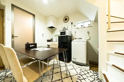 a small kitchen with a table and a refrigerator at 18, Oji B, Detached house for rent, \u738b\u5b50B in Tokyo