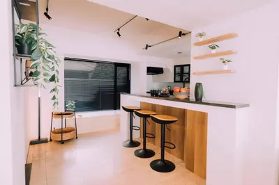 a kitchen with a counter and stools in a room at One Shibuya Hill: Urban Oasis in Tokyo