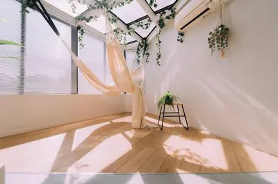 a room with a hammock hanging from a ceiling at One Shibuya Hill: Urban Oasis in Tokyo