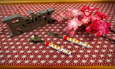 a table with some flowers and a pair of scissors at Relax place in Tokyo