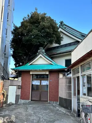 a building with a door with a tree on top at Relax place in Tokyo