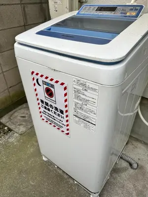 a cooler sitting on the ground with stickers on it at Relax place in Tokyo