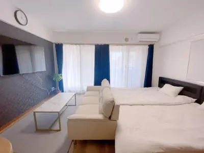 a living room with a bed and a couch at Sunshine in Tokyo