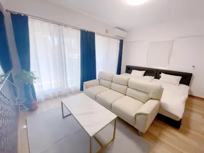 a living room with a couch and a table at Sunshine in Tokyo