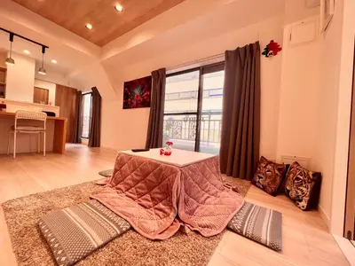 a living room with a table and a large window at High-end Tokyo shinjuku Central Park Flat 5 in Tokyo