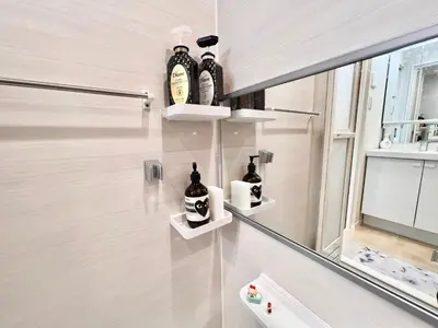 a bathroom with three shelves on the wall at High-end Tokyo shinjuku Central Park Flat 5 in Tokyo