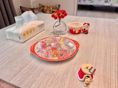a table with a plate of candy and a vase of flowers at High-end Tokyo shinjuku Central Park Flat 5 in Tokyo
