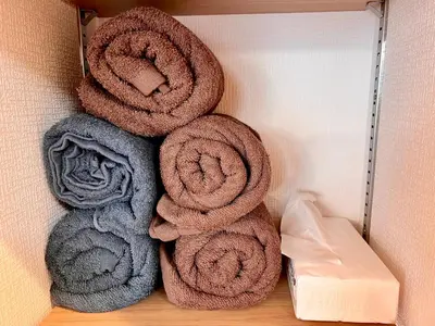 a pile of towels sitting on a shelf at High-end Tokyo shinjuku Central Park Flat 5 in Tokyo