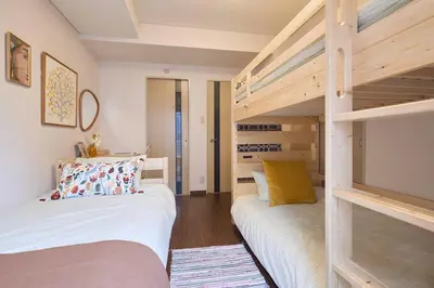 a bedroom with two bunk beds and a tv at Liberty house208 /Shibuya 5min by train Sangenjaya in Tokyo
