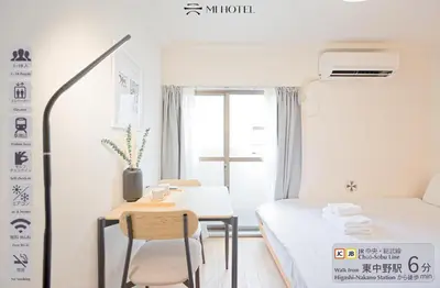a bedroom with a desk and a bed and a table at Mi-APT SHIRO in Tokyo