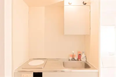 a small kitchen with a sink and a white cabinet at Mi-APT SHIRO in Tokyo