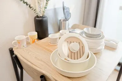 a wooden table with cups and dishes on it at Mi-APT SHIRO in Tokyo