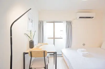 a small room with a bed and a table at Mi-APT SHIRO in Tokyo
