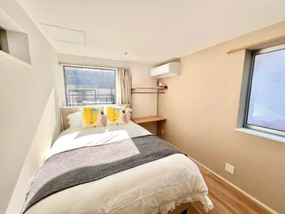 a small bedroom with a bed and a window at Kenki Ueno House-TT0170 in Tokyo