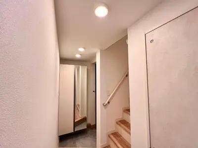 a hallway with a door and stairs in a house at Kenki Ueno House-TT0170 in Tokyo
