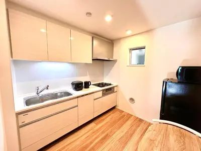 a small kitchen with a sink and a refrigerator at Kenki Ueno House-TT0170 in Tokyo