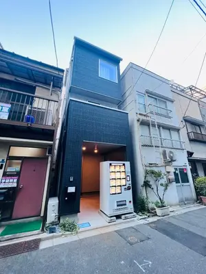 a large house with a door in the middle of a street at Kenki Ueno House-TT0170 in Tokyo