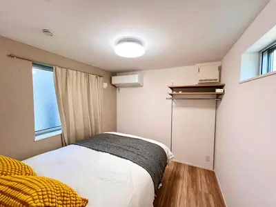 a small bedroom with a bed and a window at Kenki Ueno House-TT0170 in Tokyo