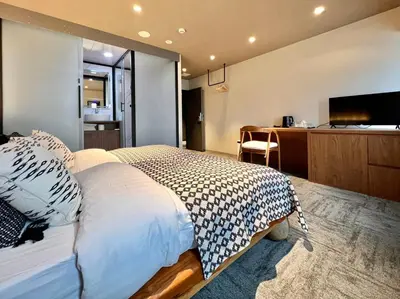 a bedroom with a large bed and a desk at LANG HOTEL Ueno # free Breakfast in Tokyo
