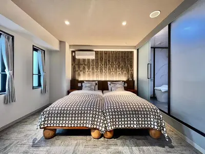 a bedroom with a large bed with two pillows at LANG HOTEL Ueno # free Breakfast in Tokyo