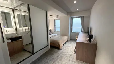 a bathroom with a mirror and a bed in a room at LANG HOTEL Ueno # free Breakfast in Tokyo