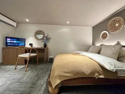 a bedroom with a bed and a desk and a television at LANG HOTEL Ueno # free Breakfast in Tokyo