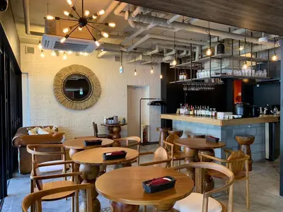 a restaurant with wooden tables and chairs and a bar at LANG HOTEL Ueno # free Breakfast in Tokyo