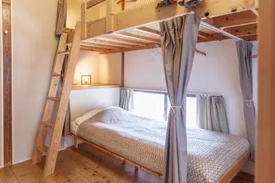 a bedroom with a bunk bed and a ladder at Tokyo Hikari Guesthouse in Tokyo