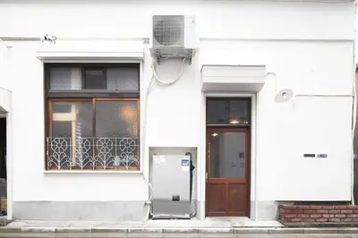 a white house with a door and a window at Tokyo Hikari Guesthouse in Tokyo