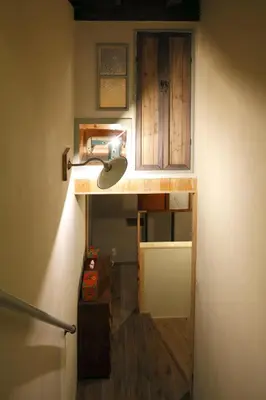 a light on a wall in a room with a hallway at Tokyo Hikari Guesthouse in Tokyo