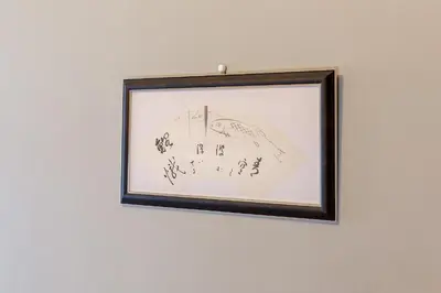 a framed drawing of a mountain on a wall at Tokyo Hikari Guesthouse in Tokyo