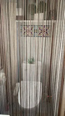 a bathroom with a toilet through a shower curtain at \u8fa3\u6912\u6c11\u5bbf in Tokyo