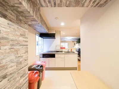 a kitchen with white cabinets and a brick wall at Shinjuku, 1min walk from Kagurazaka Sta,80sqm,Family-Friendly, in Tokyo