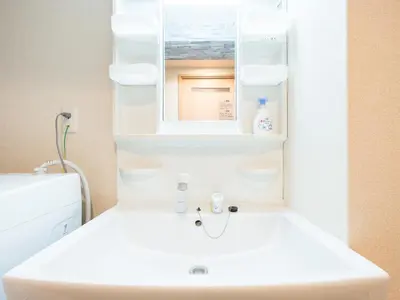 a bathroom with a white sink and a mirror at Shinjuku, 1min walk from Kagurazaka Sta,80sqm,Family-Friendly, in Tokyo