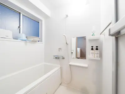 a white bathroom with a shower and a sink at Shinjuku, 1min walk from Kagurazaka Sta,80sqm,Family-Friendly, in Tokyo